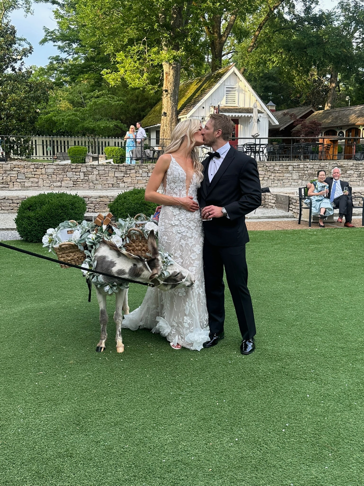 Newlyweds sharing a kiss beside Peaches and Hickory
